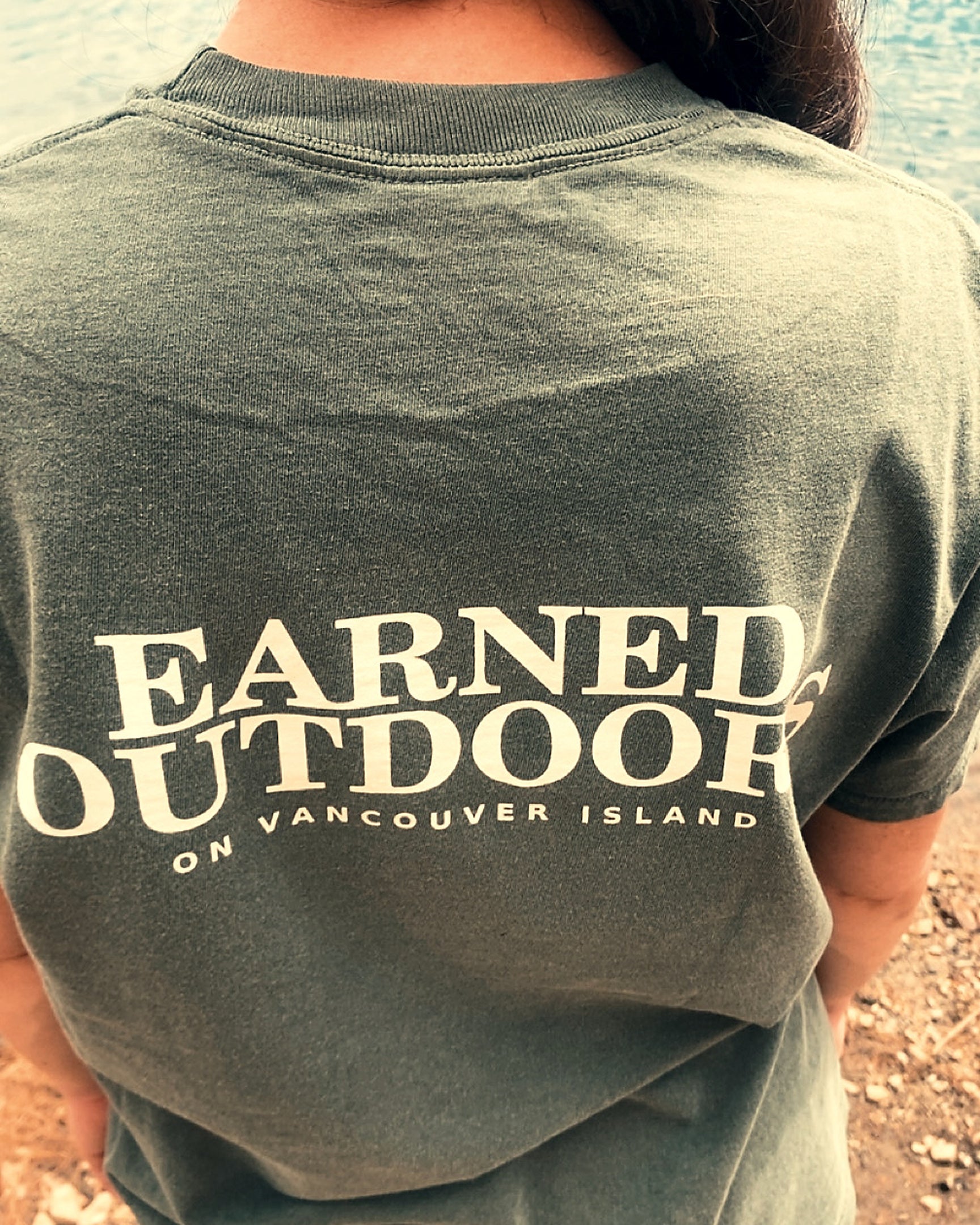 The Long Haul Tee in moss with Earned Outdoors on Vancouver Island printed across the back