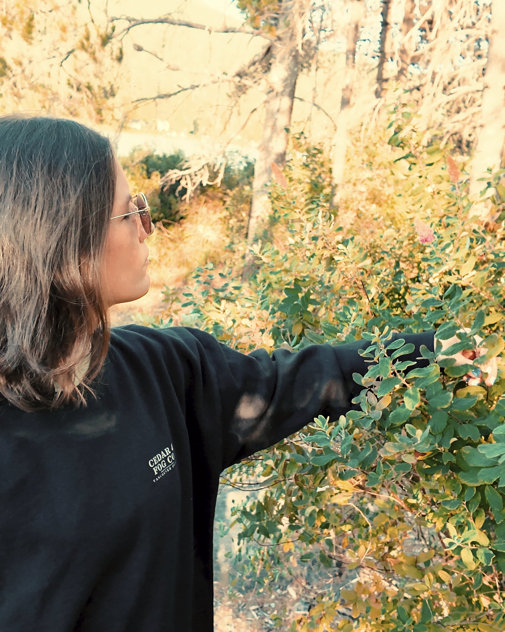 The Nightfall Crew in black worn among autumn foliage on Vancouver Island