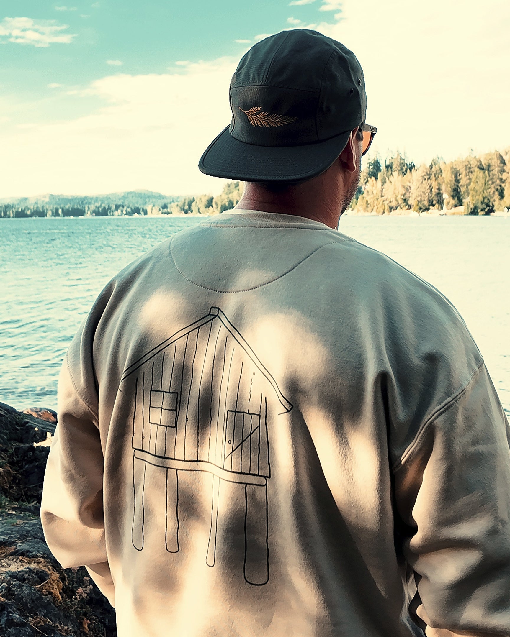 The Cabin Crew in bone on the shoreline rocks, hand-drawn cabin back print