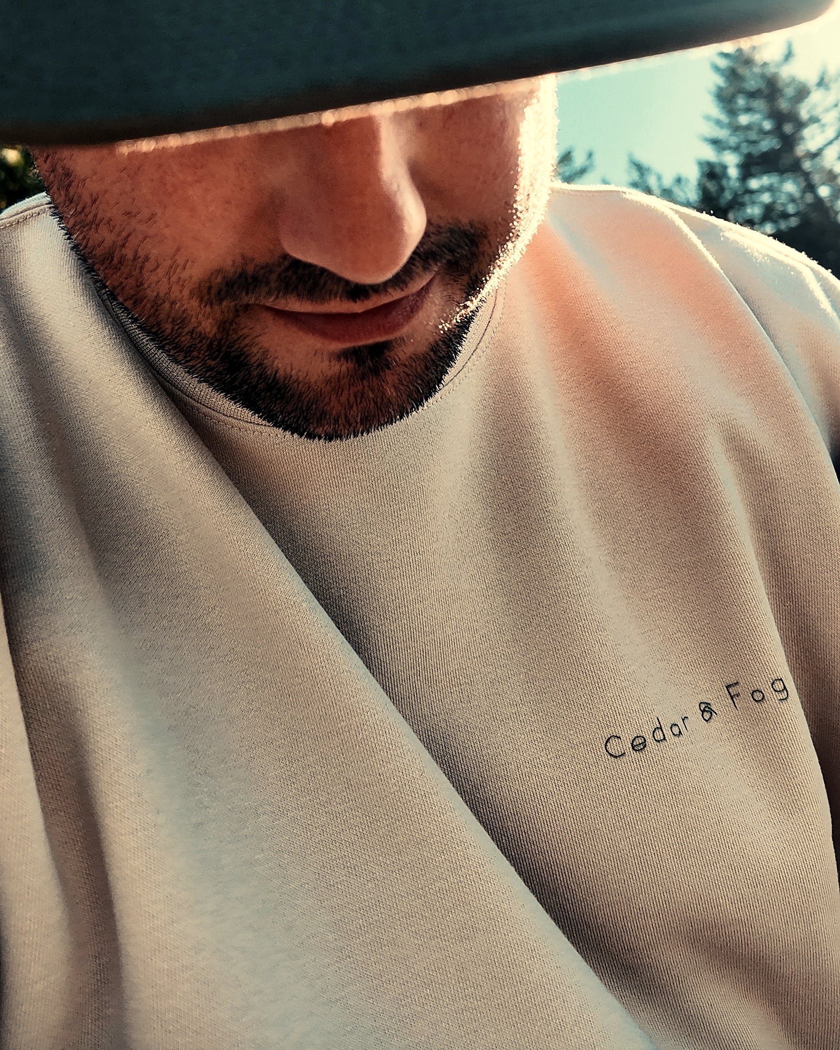The Cabin Crew in bone worn outdoors, Cedar & Fog Co. chest wordmark