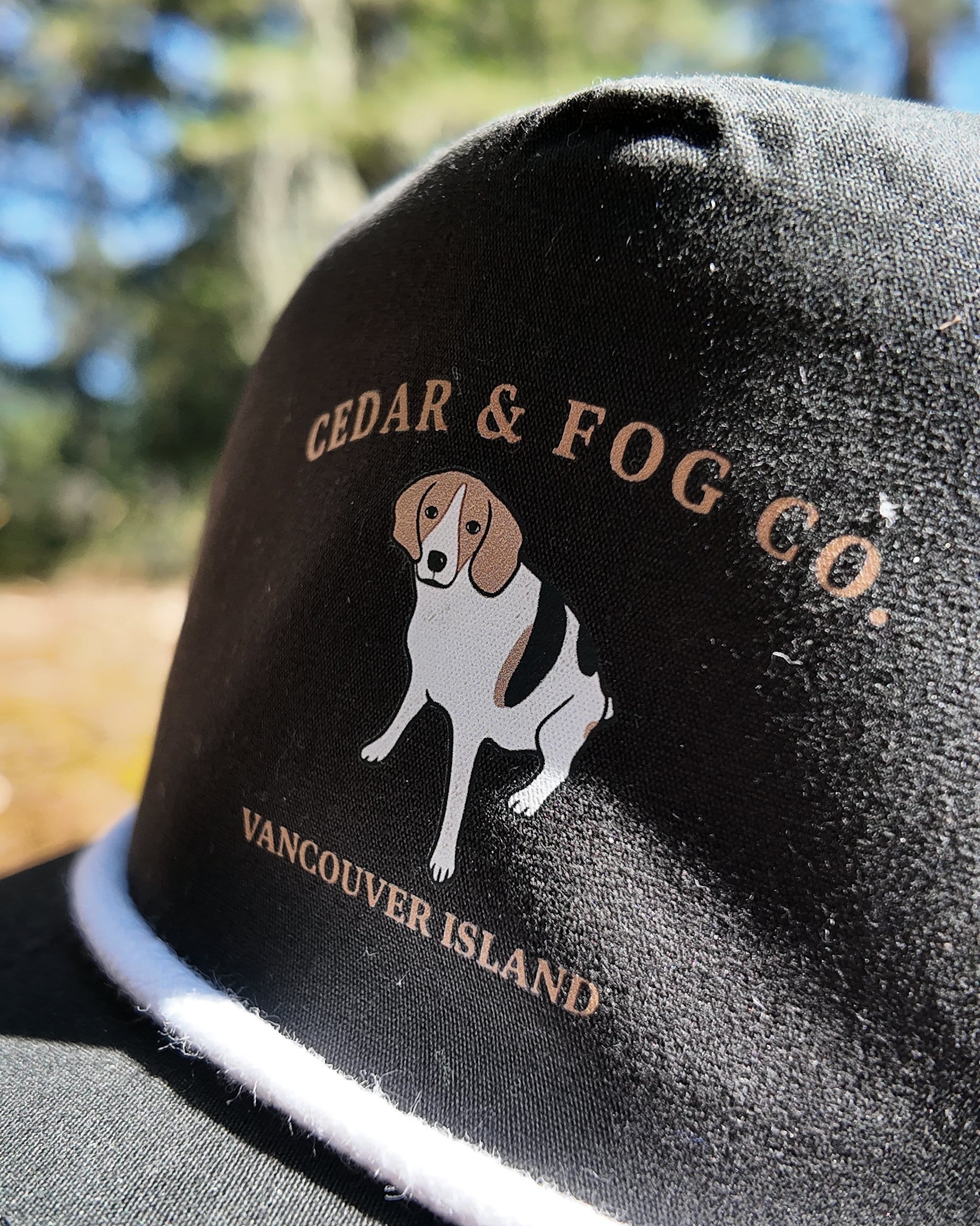 Close-up of the coonhound embroidery and Cedar & Fog Co. Vancouver Island lettering on the Georgia Cap