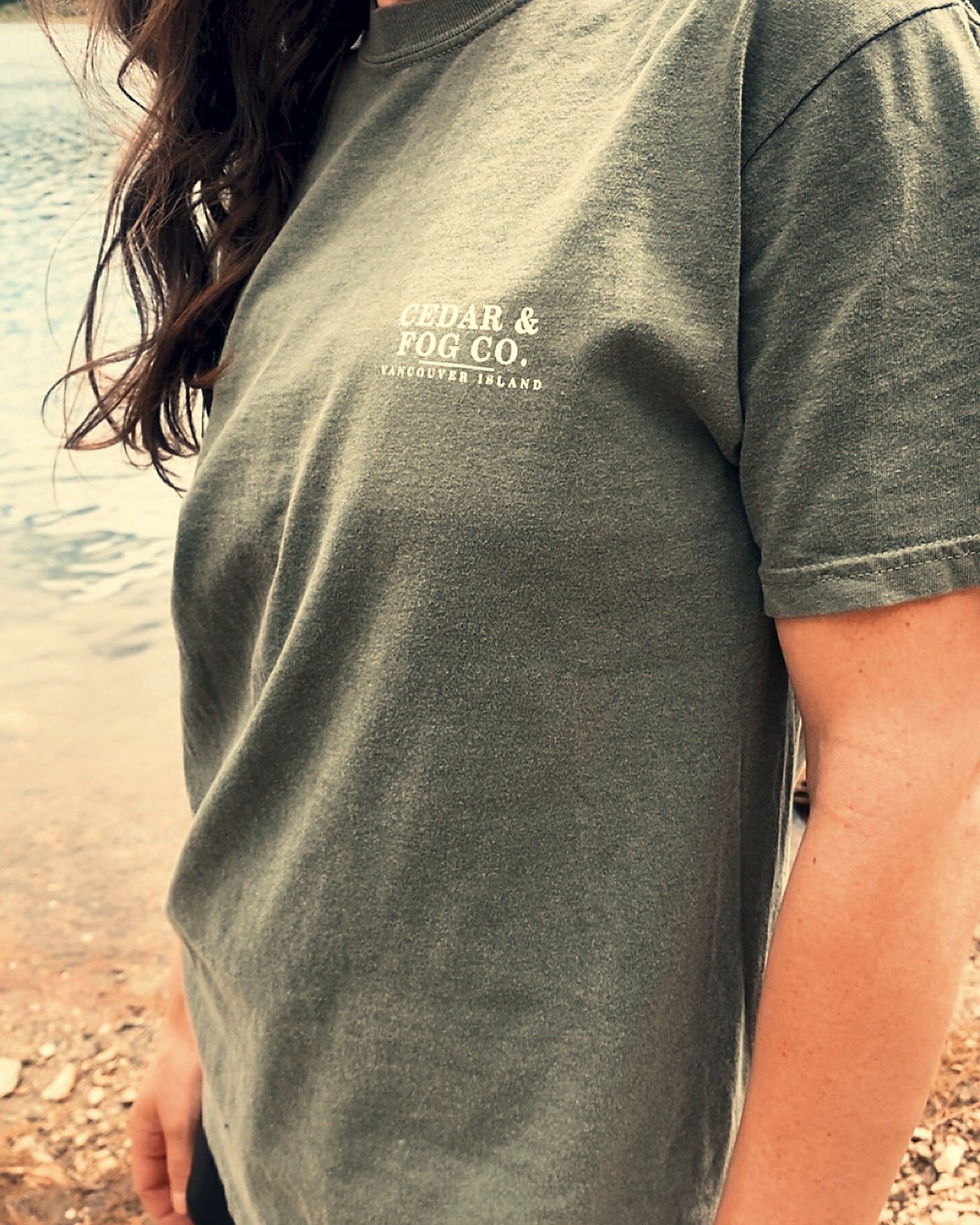 The Long Haul Tee in moss on the shoreline, Cedar & Fog Co. chest wordmark