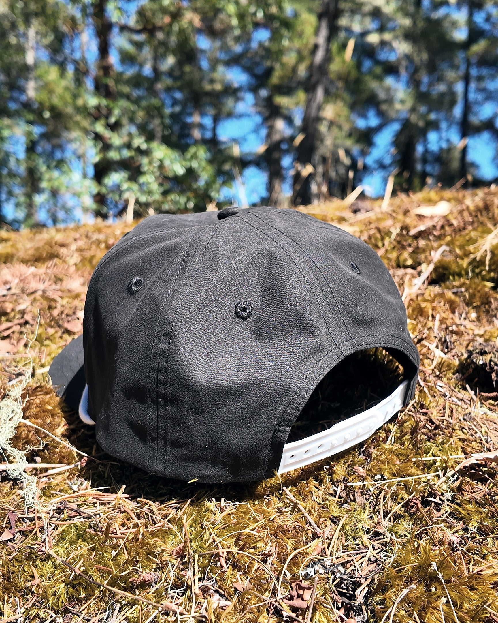 The Georgia Cap in black, back view showing the snapback closure