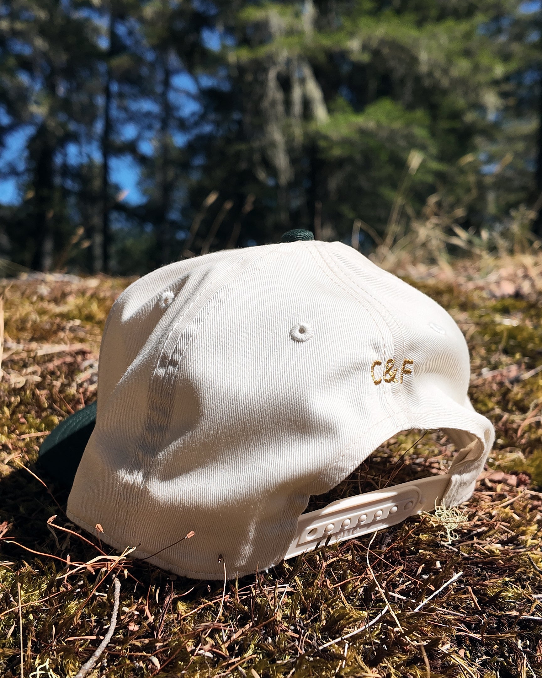 The Ranger Cap in natural, side profile showing the C&F embroidery